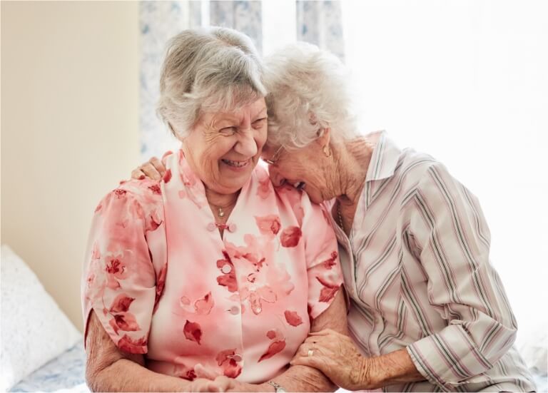 two women smiling at each other