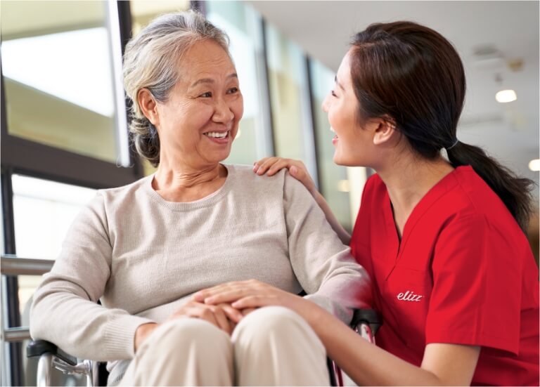 Nurse smiling at elderly patient